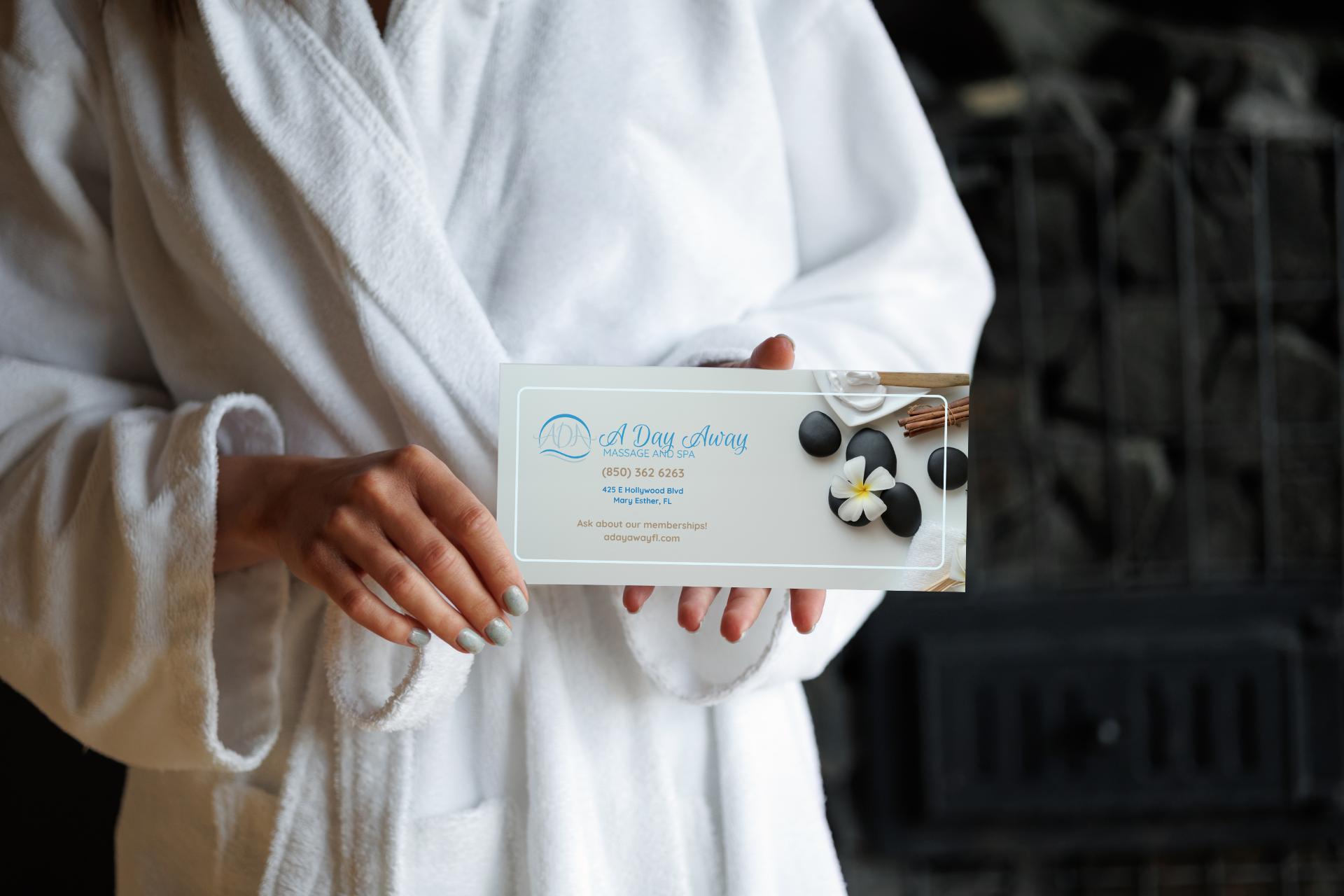 A woman in a fluffy, white robe holding a gift certificate